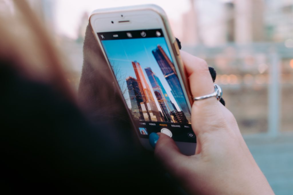 Woman taking photo of skyline