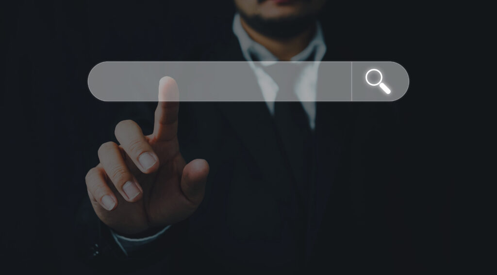 Man in a business suit touches search engine bar