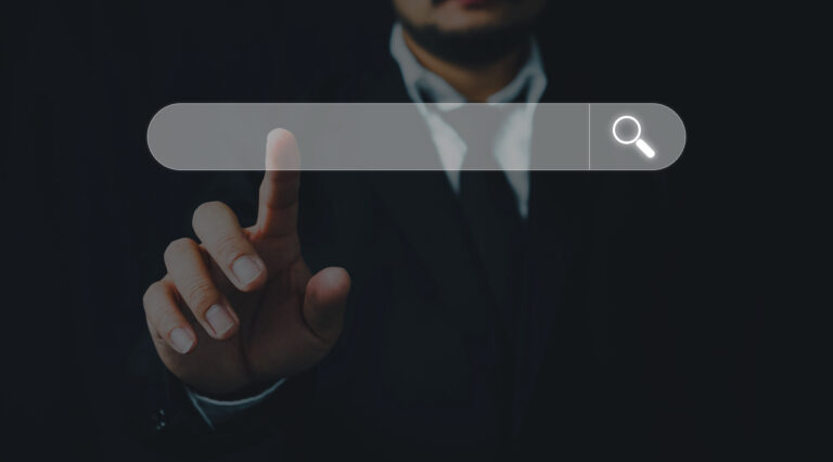 Man in a business suit touches search engine bar